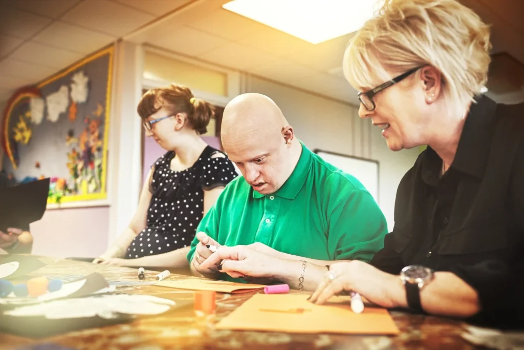 Support worker assisting participant with activity