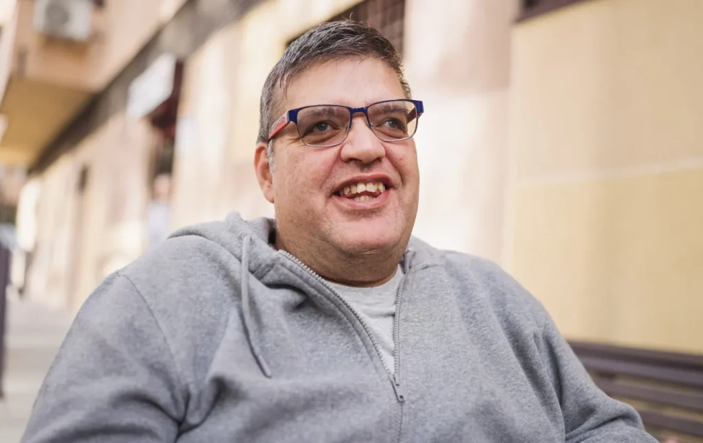 Man with disability smiling outdoors